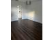 Bright bedroom featuring modern light fixture and rich dark wood-look laminate flooring at 2900 S Semoran Blvd # 1, Orlando, FL 32822