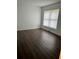 This is a bedroom with wood floors and a window at 2900 S Semoran Blvd # 1, Orlando, FL 32822