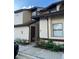 Beige condo with brown trim and landscaping at 2900 S Semoran Blvd # 1, Orlando, FL 32822