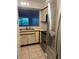 Bright kitchen featuring tile floors, stainless steel appliances, and convenient pass-through at 2900 S Semoran Blvd # 1, Orlando, FL 32822