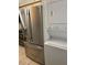 Stainless steel refrigerator and stacked washer/dryer combination in laundry area at 2900 S Semoran Blvd # 1, Orlando, FL 32822