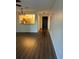 Open-concept living room featuring sleek laminate flooring at 2900 S Semoran Blvd # 1, Orlando, FL 32822