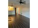 Bright living room featuring laminate flooring and a ceiling fan at 2900 S Semoran Blvd # 1, Orlando, FL 32822