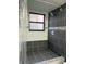 Shower featuring gray and white tiling, a shower window, and mosaic tile accents at 2900 S Semoran Blvd # 1, Orlando, FL 32822