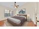 Virtually staged bedroom with neutral colors, ceiling fan and laminate wood floors at 2907 Prince Oak Ct, St Cloud, FL 34769