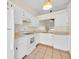 Bright kitchen featuring white cabinets, appliances, and tile flooring at 2907 Prince Oak Ct, St Cloud, FL 34769