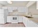 Bright kitchen featuring white cabinets, appliances, and tile flooring at 2907 Prince Oak Ct, St Cloud, FL 34769