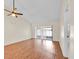 Open living room with vaulted ceiling, ceiling fan and sliding glass doors to the exterior at 2907 Prince Oak Ct, St Cloud, FL 34769