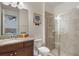 Bathroom showcasing a vanity with granite countertops and a walk-in shower with glass doors at 331 Pendant Ct, Kissimmee, FL 34747