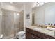 Bathroom featuring a glass shower and a vanity with a granite countertop and dark wood cabinets at 331 Pendant Ct, Kissimmee, FL 34747
