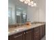 Bathroom features double sink vanity with granite countertops and a glass enclosed walk-in shower at 331 Pendant Ct, Kissimmee, FL 34747