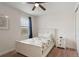 This bedroom features carpeted floors, a ceiling fan, and a side table at 331 Pendant Ct, Kissimmee, FL 34747