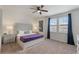 This bedroom features plush carpets, windows with curtains, ceiling fan, and side tables at 331 Pendant Ct, Kissimmee, FL 34747