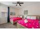 Carpeted bedroom includes two beds, a ceiling fan, and a window with curtains at 331 Pendant Ct, Kissimmee, FL 34747