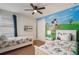 This bedroom features twin beds and a wall mural at 331 Pendant Ct, Kissimmee, FL 34747