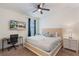 This carpeted bedroom features a ceiling fan, side table, and a wall-mounted TV at 331 Pendant Ct, Kissimmee, FL 34747