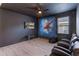 Bonus room with dark walls and floors, a Spiderman wall mural, and a wall mounted television at 331 Pendant Ct, Kissimmee, FL 34747