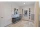 Bright entryway featuring a tiled floor, decorative mirror, and ample natural light at 331 Pendant Ct, Kissimmee, FL 34747