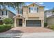 Charming two-story home featuring a brick driveway and a well-maintained lawn, perfect for Gathering living at 331 Pendant Ct, Kissimmee, FL 34747