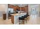Well-equipped kitchen featuring a central island with stool seating, stainless steel appliances, and tile flooring at 331 Pendant Ct, Kissimmee, FL 34747