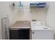 Laundry room features a full size washer and dryer with shelving above at 331 Pendant Ct, Kissimmee, FL 34747
