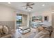 Comfortable living room featuring a ceiling fan, television, and sliding door access to the outdoor pool area at 331 Pendant Ct, Kissimmee, FL 34747