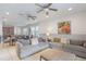 Open-concept living space with tile flooring, neutral tones, and a seamless flow to the kitchen and dining area at 331 Pendant Ct, Kissimmee, FL 34747