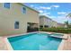 Backyard swimming pool and spa with brick patio and lush landscaping at 331 Pendant Ct, Kissimmee, FL 34747