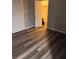 Bedroom with wood-look flooring, closet, and light-blocking vertical blinds at 4341 Aqua Vista Dr # A, Orlando, FL 32839