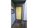 Exterior shot of a yellow front door with a small window to the side of it at 4341 Aqua Vista Dr # A, Orlando, FL 32839