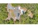 Aerial view of home with solar panels and pool in wooded area at 4410 Mildred Bass Rd, St Cloud, FL 34772