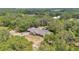Wide aerial view of the property showing the home, pool, and surrounding trees at 4410 Mildred Bass Rd, St Cloud, FL 34772