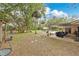 Expansive backyard featuring a playset, patio with seating, and an inviting in-ground pool surrounded by lush landscaping at 4410 Mildred Bass Rd, St Cloud, FL 34772