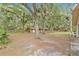 Expansive backyard features mature trees, a play area, and a small wooden cabin at 4410 Mildred Bass Rd, St Cloud, FL 34772