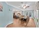 Dining room featuring blue walls, wood floors, a large table, with an adjacent view to the kitchen at 4410 Mildred Bass Rd, St Cloud, FL 34772