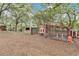 This backyard features well-maintained chicken coops, mature trees, and peaceful surroundings at 4410 Mildred Bass Rd, St Cloud, FL 34772