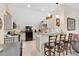 Well-lit kitchen with gray cabinets, granite countertops, and a breakfast bar with comfortable seating at 4410 Mildred Bass Rd, St Cloud, FL 34772