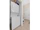 This laundry area features a stacked washer and dryer unit and a door for easy access at 4410 Mildred Bass Rd, St Cloud, FL 34772
