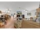 Inviting living room features a brick fireplace, hardwood floors, and open access to the kitchen and dining areas at 4410 Mildred Bass Rd, St Cloud, FL 34772