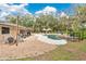Beautiful backyard with in-ground pool, patio, lounge chairs, and mature trees at 4410 Mildred Bass Rd, St Cloud, FL 34772