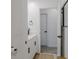 White bathroom with vanity, modern fixtures, and a view of the adjacent space at 466 Cool Summer Ln, Davenport, FL 33837