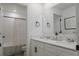 Contemporary bathroom with double sinks, tiled shower, and modern fixtures at 466 Cool Summer Ln, Davenport, FL 33837