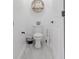 Powder room features a toilet, decorative shelf, and clean design at 466 Cool Summer Ln, Davenport, FL 33837