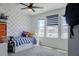 Playful bedroom with patterned accent wall, lots of natural light, and toys at 466 Cool Summer Ln, Davenport, FL 33837