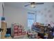 A playful ' bedroom with a crib, colorful decorations and ceiling fan at 466 Cool Summer Ln, Davenport, FL 33837