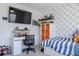 Cozy bedroom featuring a large screen television and shelves with toys at 466 Cool Summer Ln, Davenport, FL 33837