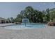 Community pool area with a fountain feature, landscaped surroundings and a spacious deck for relaxation at 466 Cool Summer Ln, Davenport, FL 33837