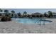 Relaxing community pool featuring a fountain, zero entry, and nearby cabana at 466 Cool Summer Ln, Davenport, FL 33837