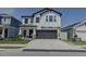 Charming two-story home featuring a two-car garage, stylish shutters, and manicured landscaping at 466 Cool Summer Ln, Davenport, FL 33837