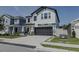 Charming two-story home featuring a two-car garage, stylish shutters, and manicured landscaping at 466 Cool Summer Ln, Davenport, FL 33837
